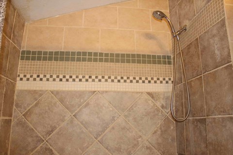 a shower in a tiled shower stall in a bathroom