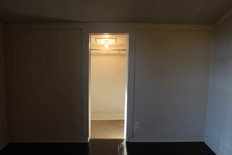 an empty room with a door and a light on the wall