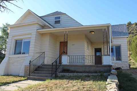 a renovated house with a front porch and steps