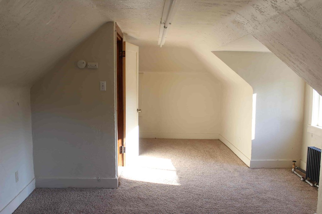 an empty room with white walls and a door