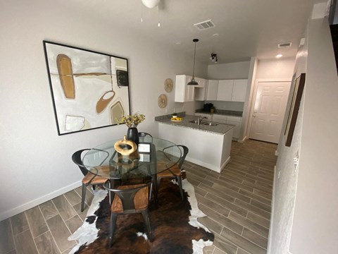 a dining room and kitchen with a table and chairs