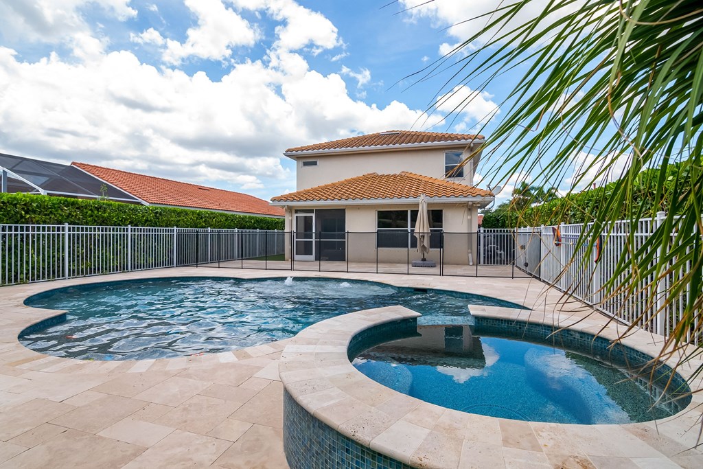 a swimming pool with a house in the background