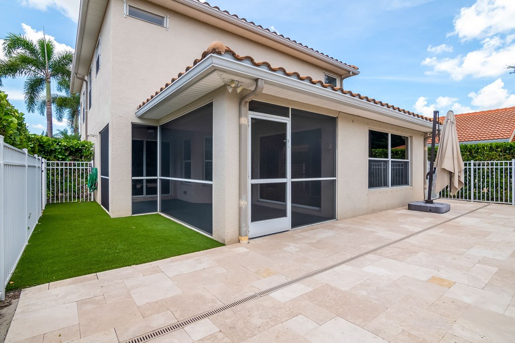 a patio with an umbrella on the side of a house