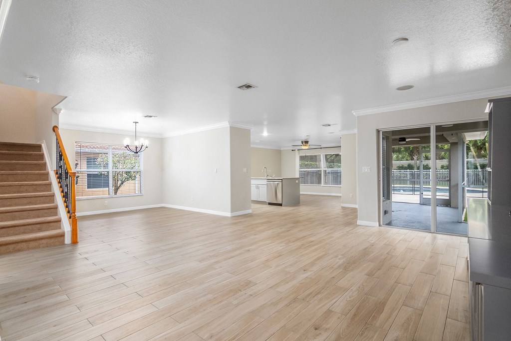 the living room and dining room of a new home with a hardwood floor and