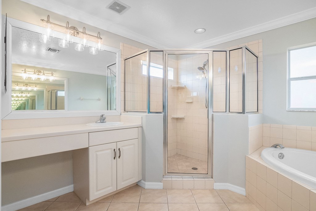 a bathroom with a shower and a sink and a mirror