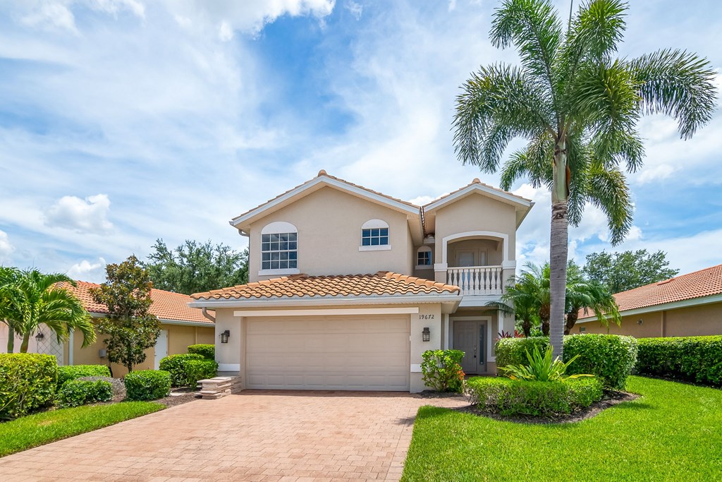a house with palm trees in front of it