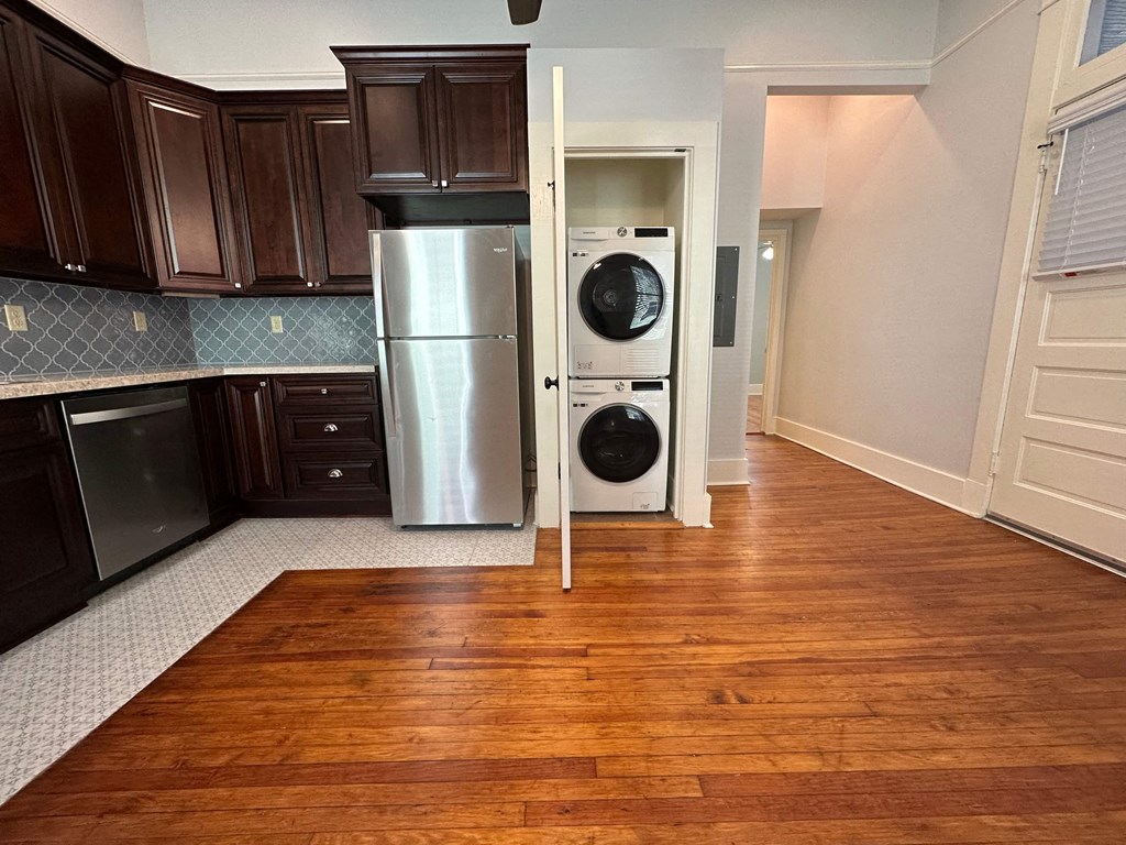 a kitchen with a washer and a dryer in it