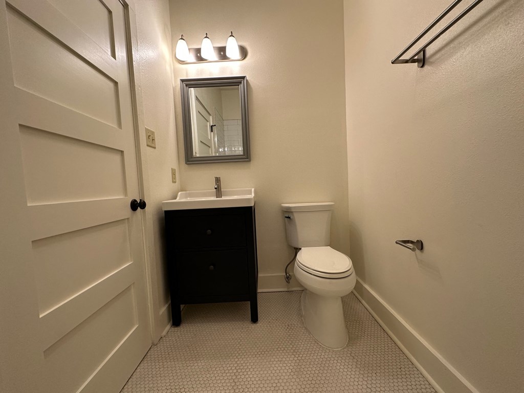 a bathroom with a toilet and a sink and a mirror
