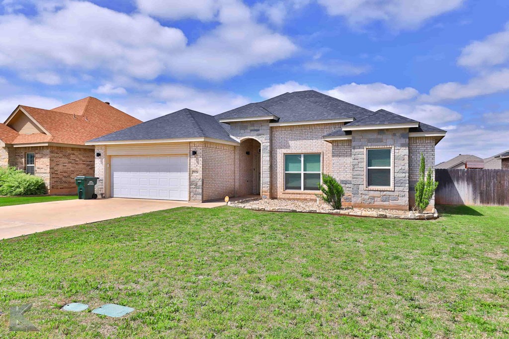 A house with a garage and a driveway.