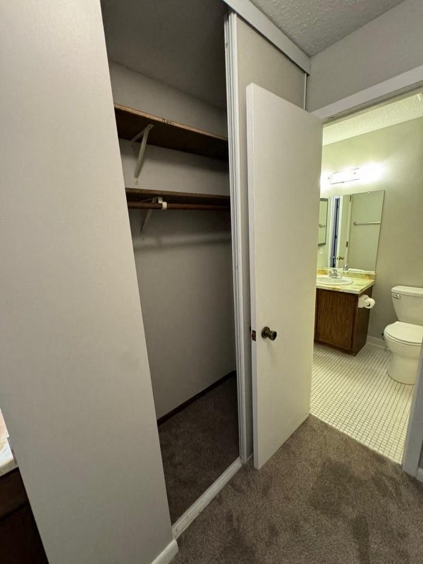 an empty bathroom with a toilet and a sink