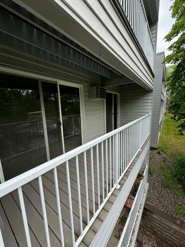 a white railing on a balcony of a house
