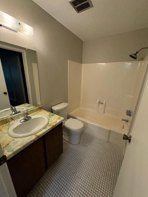 a bathroom with a toilet and a sink and a shower