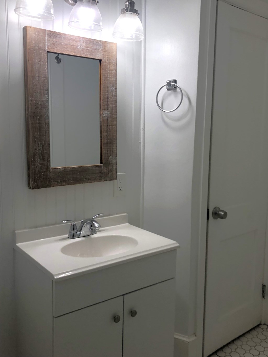 a small bathroom with a sink and a mirror