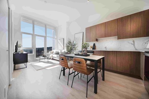 A modern kitchen with a dining table and chairs.