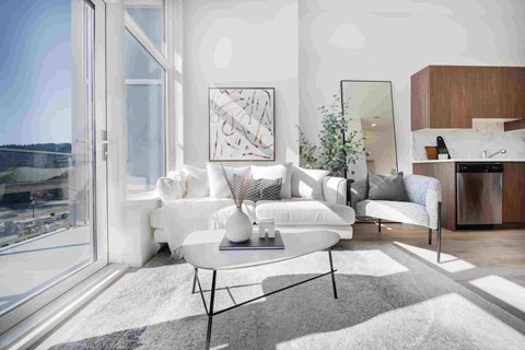 A modern living room with a large window overlooking a body of water.
