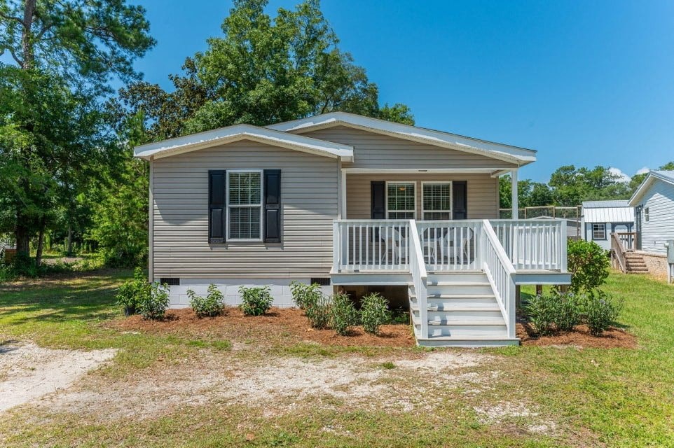 a small house with a porch and a staircase