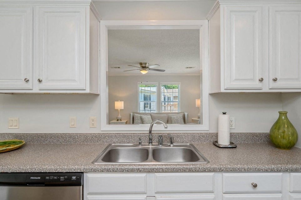 a kitchen with a sink and a mirror