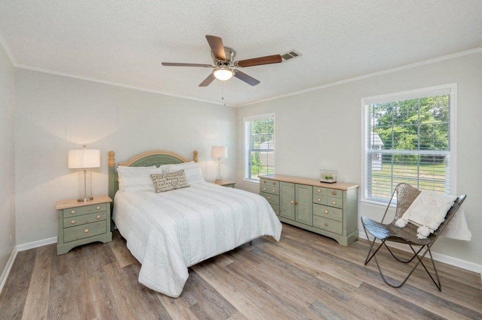 a bedroom with a bed and a ceiling fan