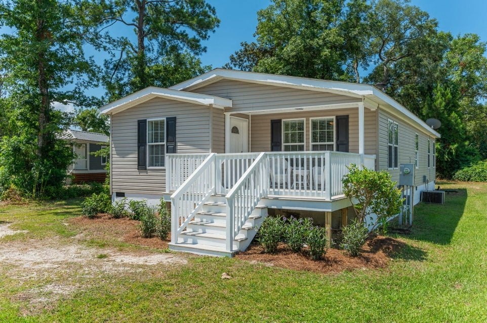 a small house with a porch and a staircase