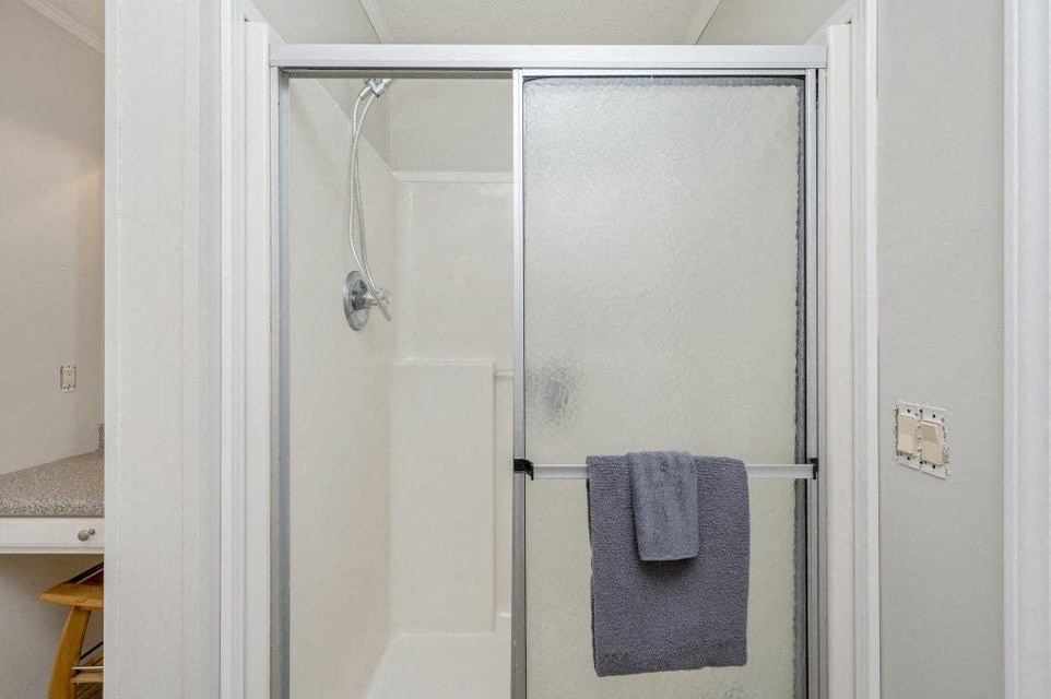 a bathroom with a shower and a towel in it
