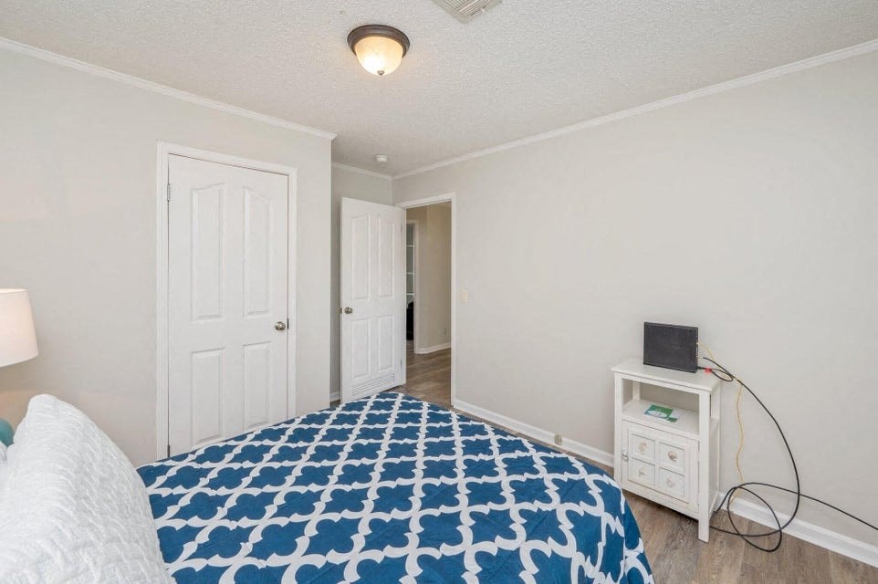 a bedroom with a bed and a door to a hallway