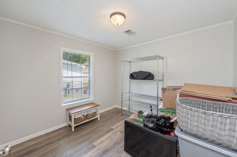 the living room is full of boxes and a tv