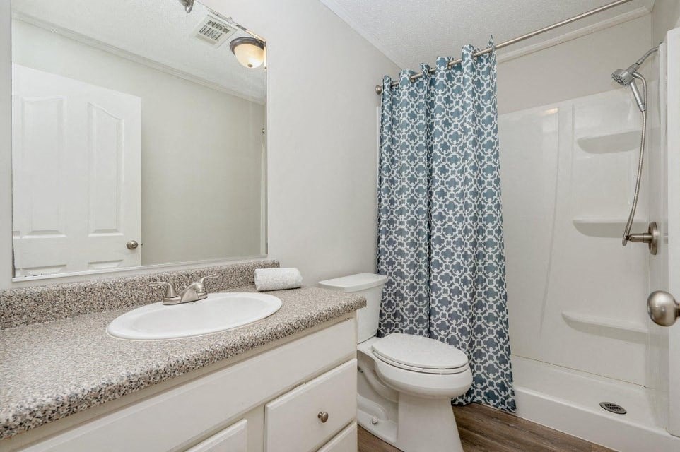 a bathroom with a sink toilet and a shower