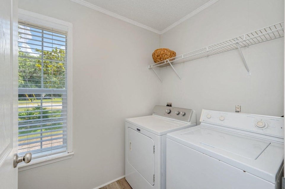 a white washer and dryer in a room with a window