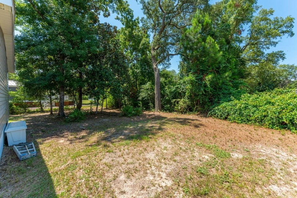 large yard with trees and grass and a house