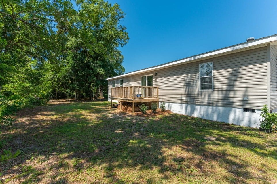 a white house with a backyard and a deck
