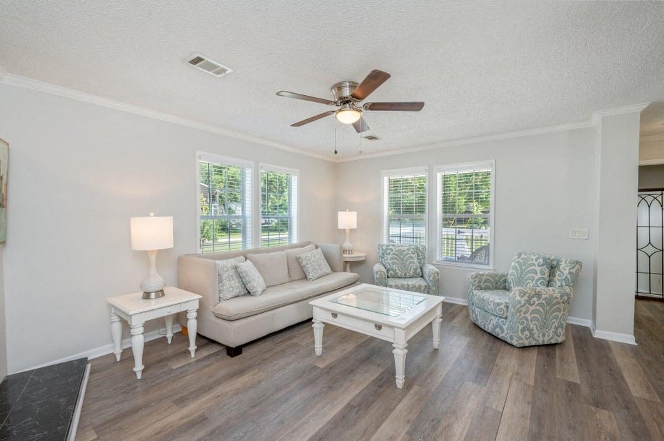 a living room with furniture and a ceiling fan