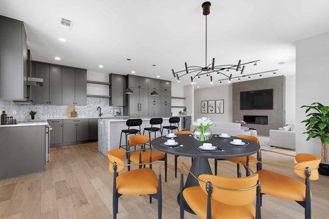 a dining room and kitchen with a table and chairs