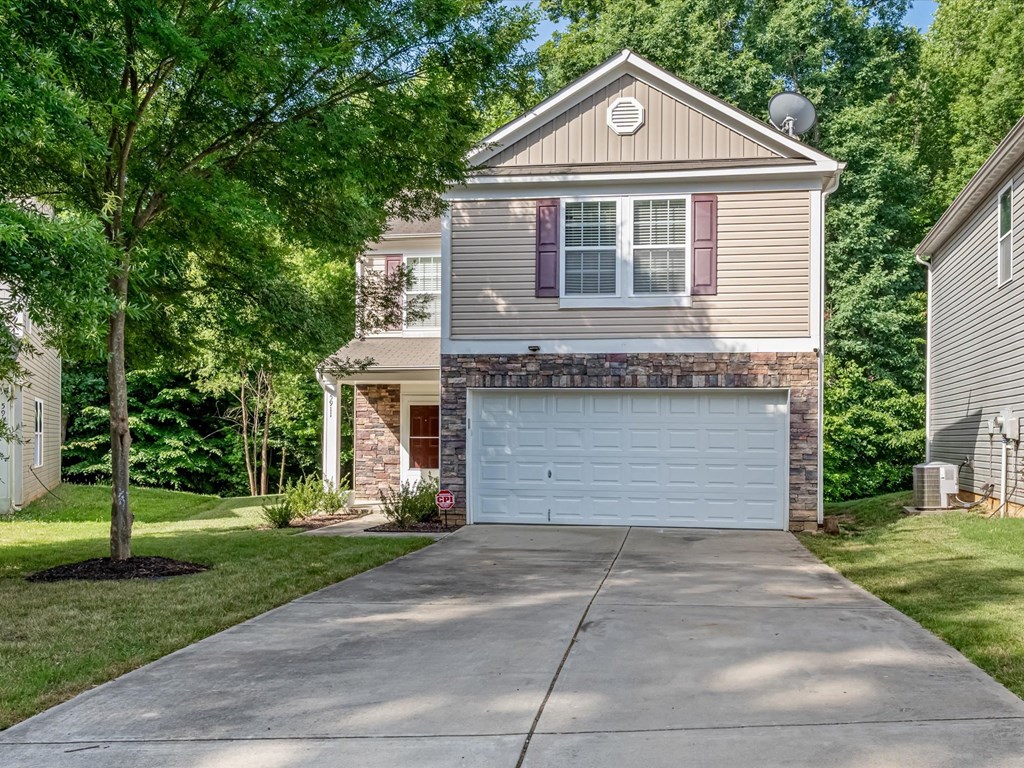 a house with a white garage door on a driveway