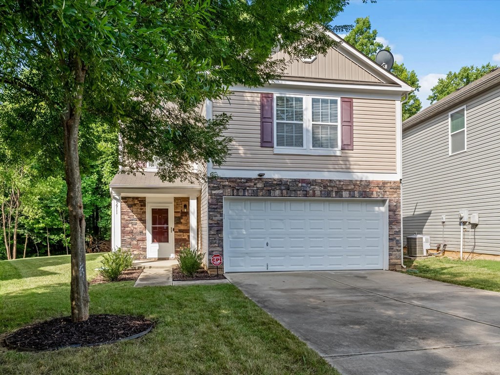 a house with a white garage door on a driveway