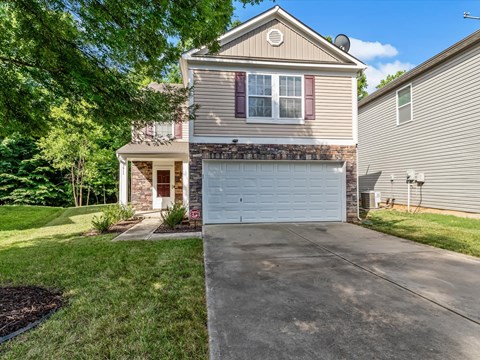 a house with a white garage door on a driveway