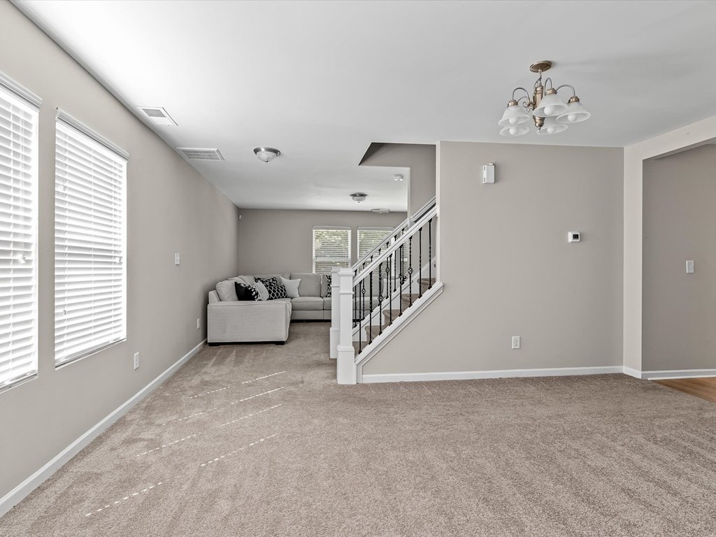 a living room with a staircase and a couch