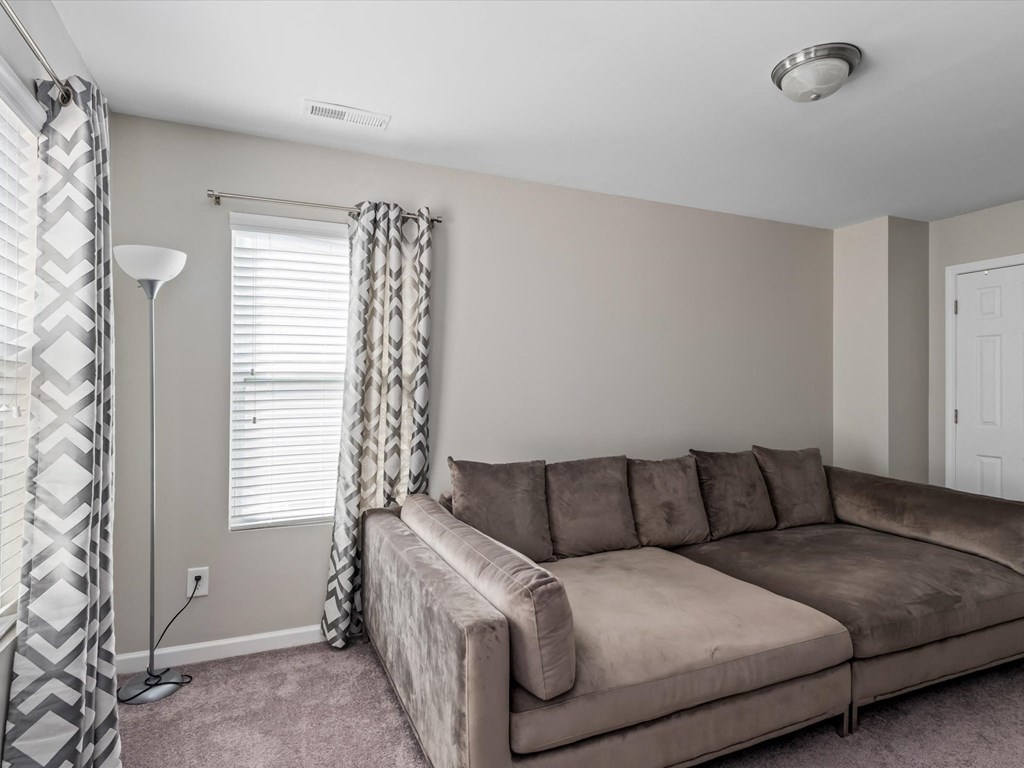 a living room with a couch and a window