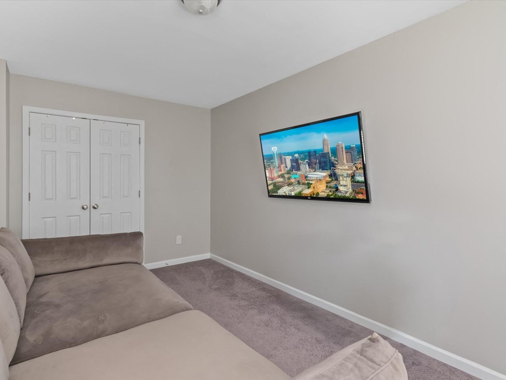 a living room with a couch and a tv on the wall