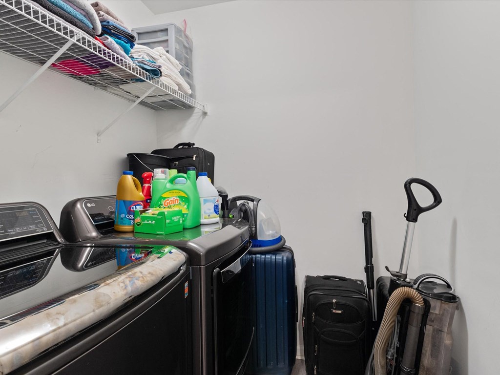 a kitchen with a sink and a counter top with a refrigerator and a dishwasher