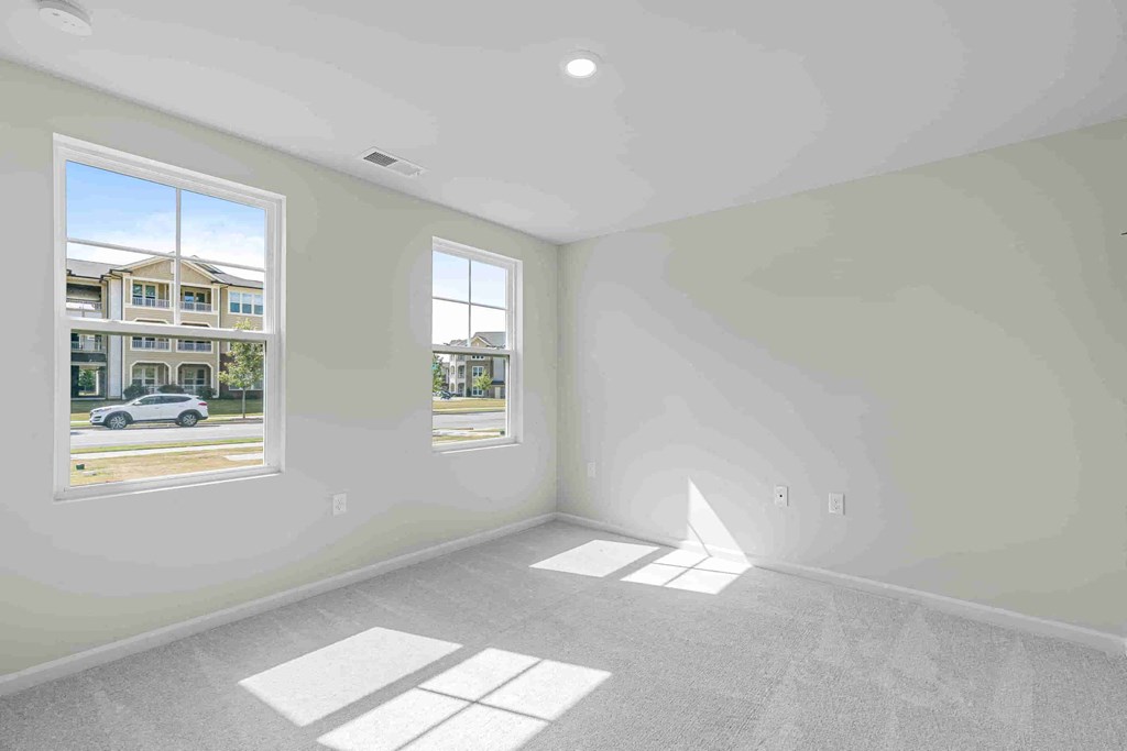 a living room with a large window and white walls