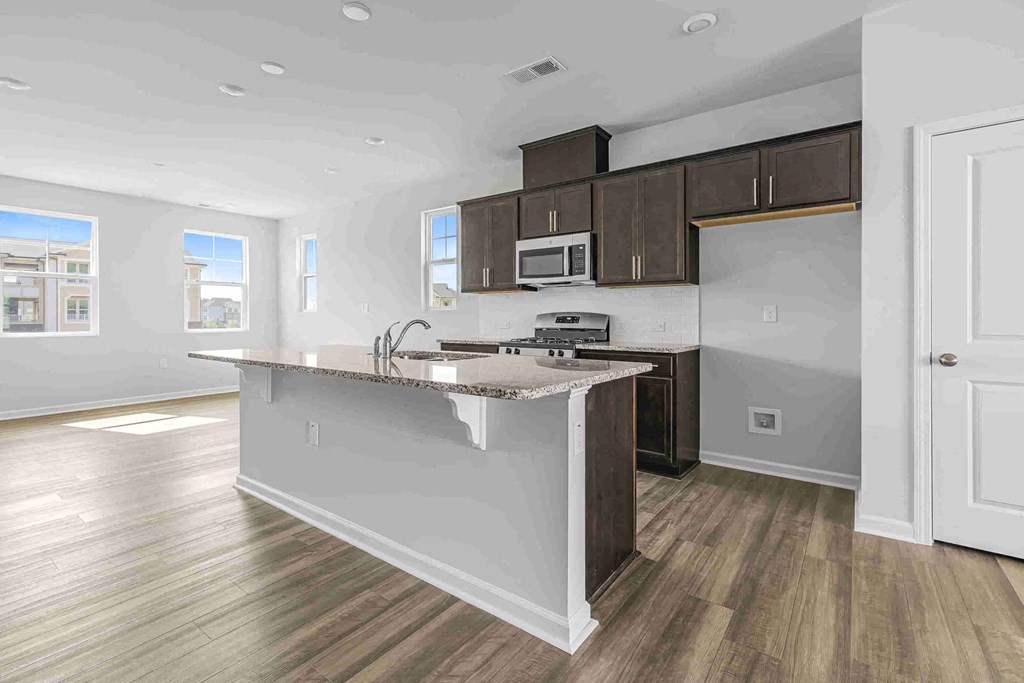 an empty kitchen with an island in the middle