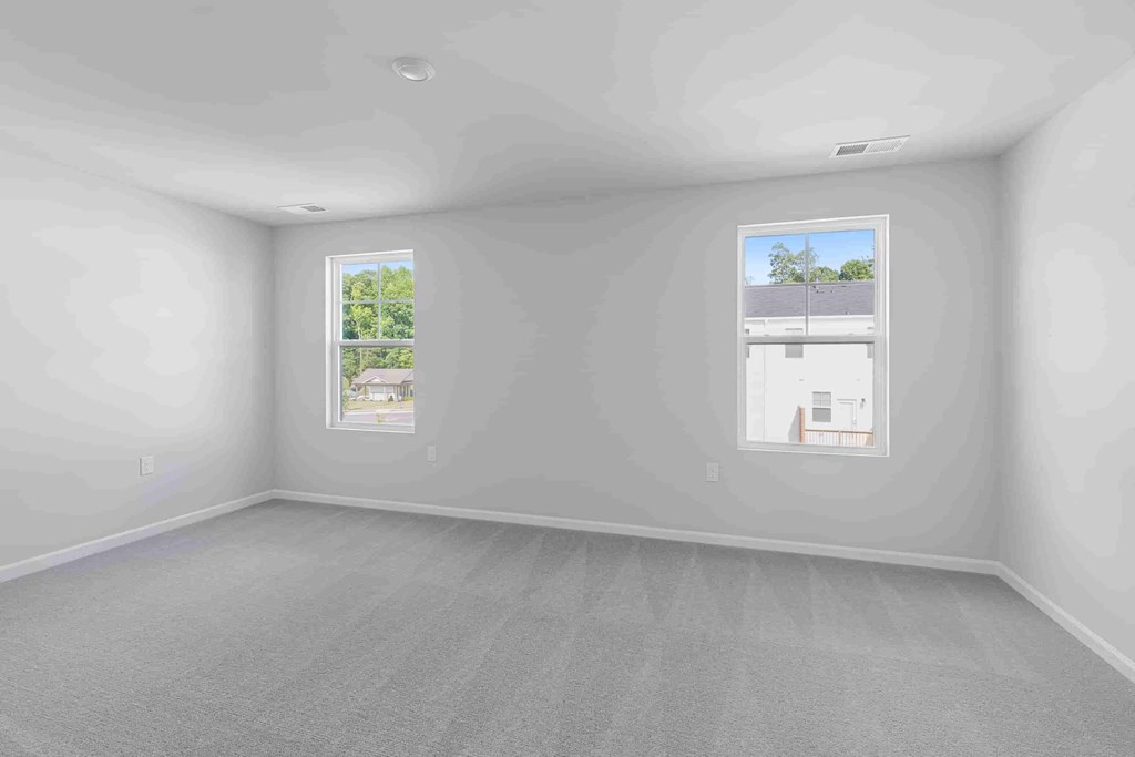 an empty room with two windows in it