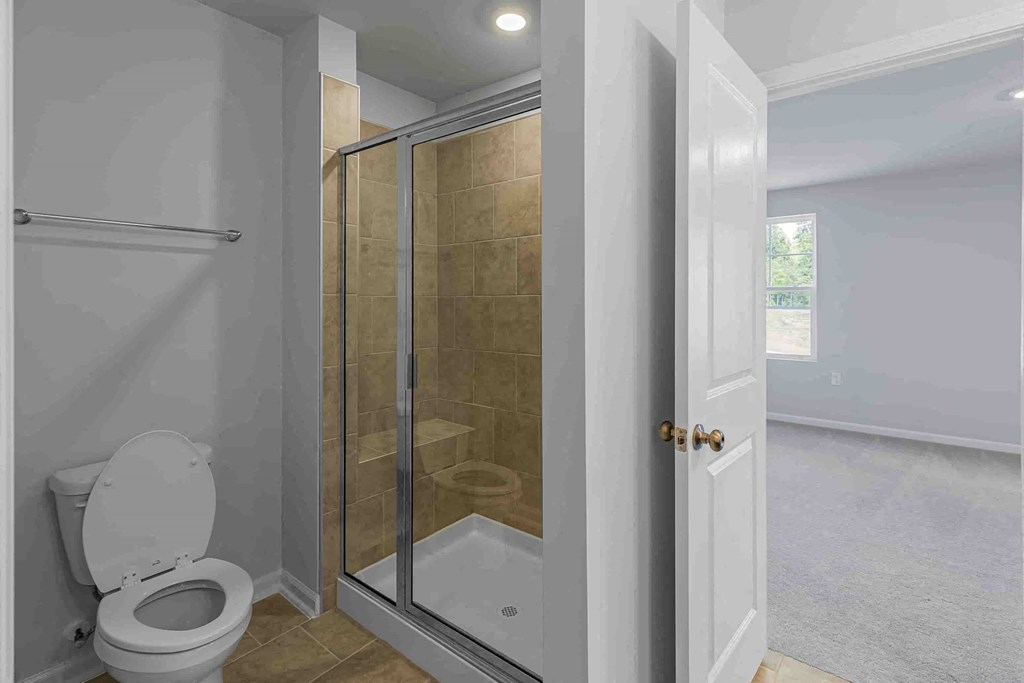 a bathroom with a shower and a toilet in it