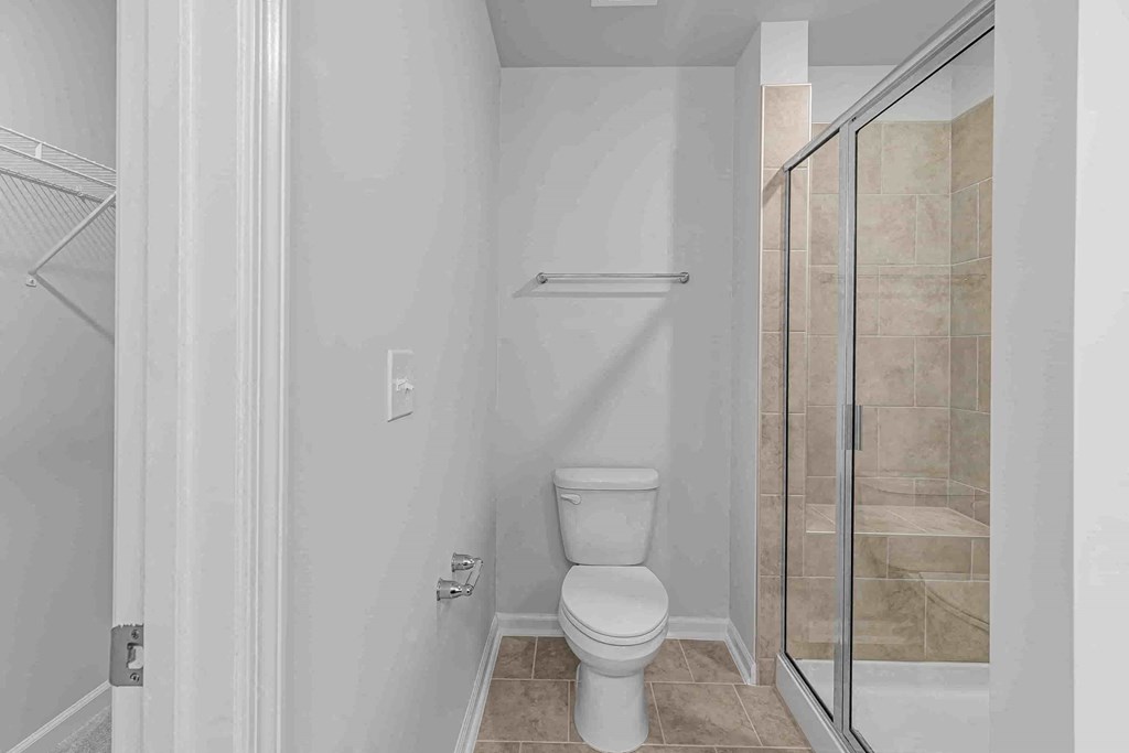 a bathroom with a toilet and a shower in it