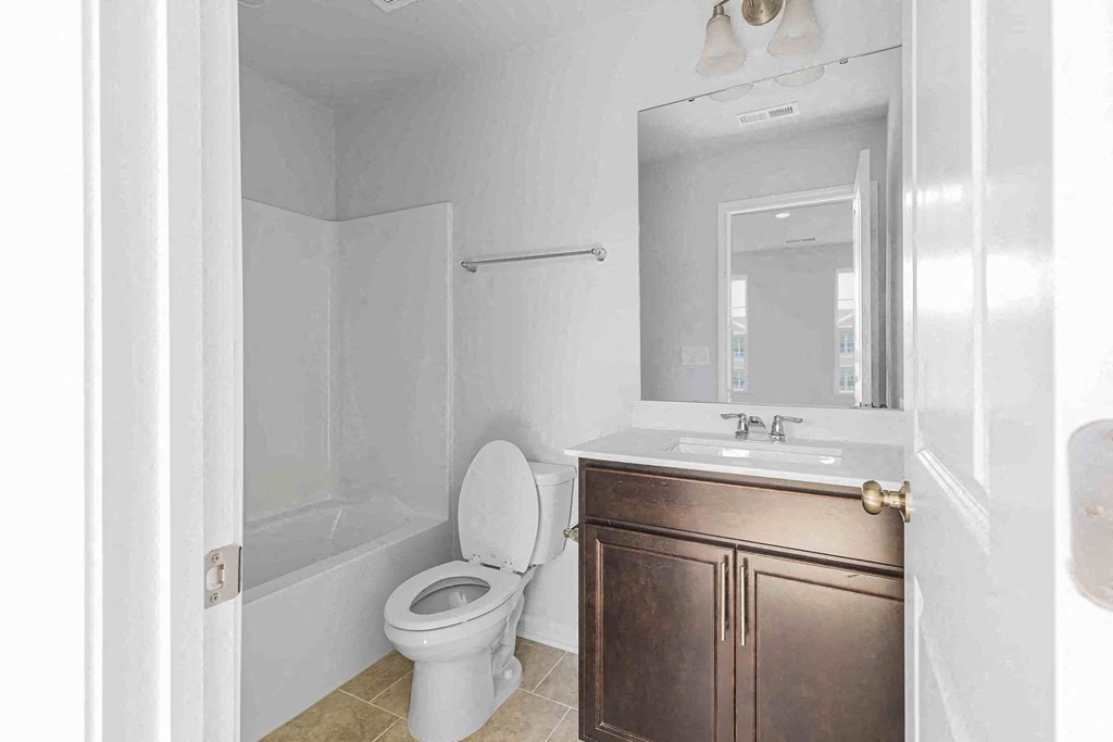 a bathroom with a sink toilet and a bath tub