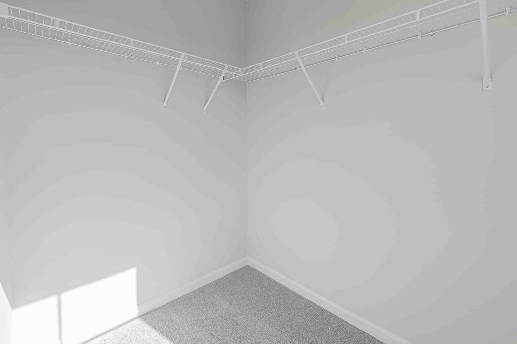 an empty room with white walls and fluorescent lights on the ceiling