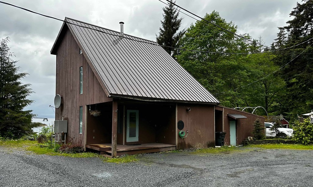 a small brown house with a metal roof