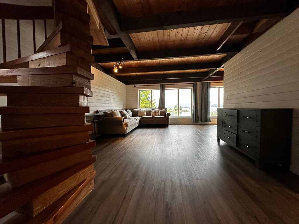 a living room with a couch and a wooden floor