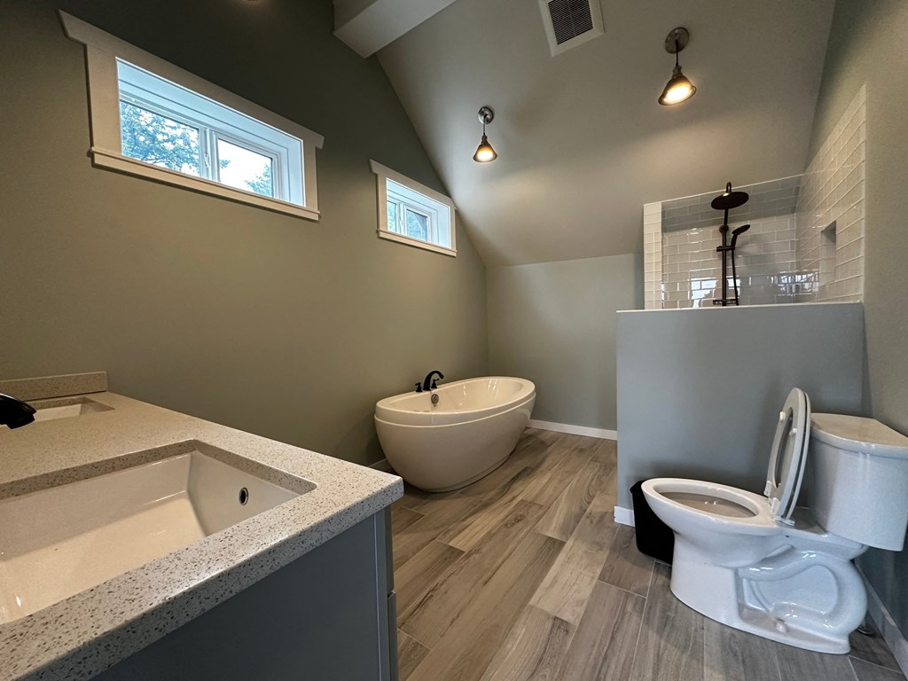 a bathroom with a toilet and a bath tub and a sink