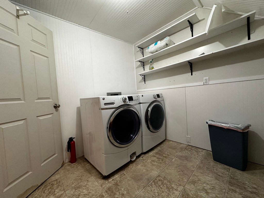 a washer and dryer in a laundry room with white walls